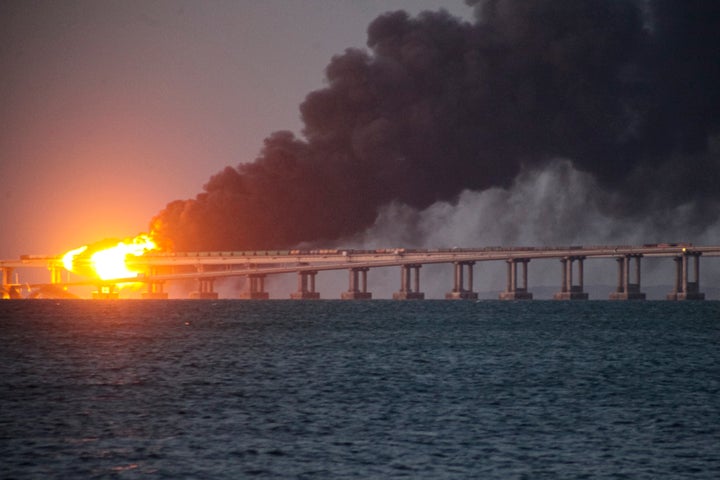 Flame and smoke rise from the Crimean Bridge connecting Russian mainland and the Crimean peninsula over the Kerch Strait, in Kerch, Crimea, Oct. 8, 2022.