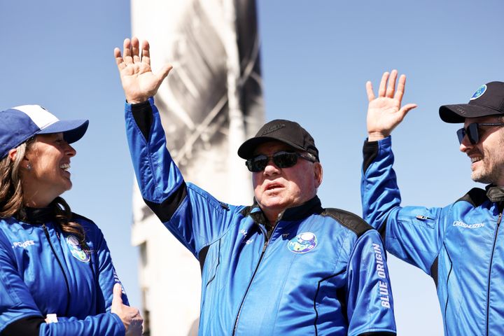 (L-R) Blue Origins vice president of mission and flight operations Audrey Powers, Star Trek actor William Shatner, and Planet Labs co-founder Chris Boshuizen wave during a media availability on the landing pad of Blue Origin’s New Shepard after they flew into space on October 13, 2021.