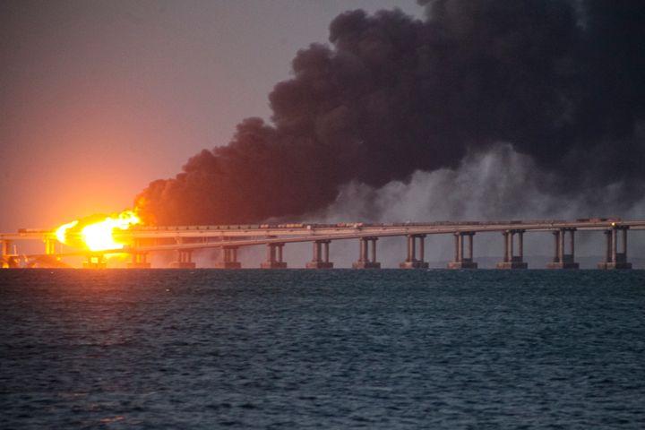Flame and smoke rise from the Crimean Bridge connecting Russian mainland and the Crimean peninsula over the Kerch Strait, in Kerch, Crimea, Oct. 8, 2022. 