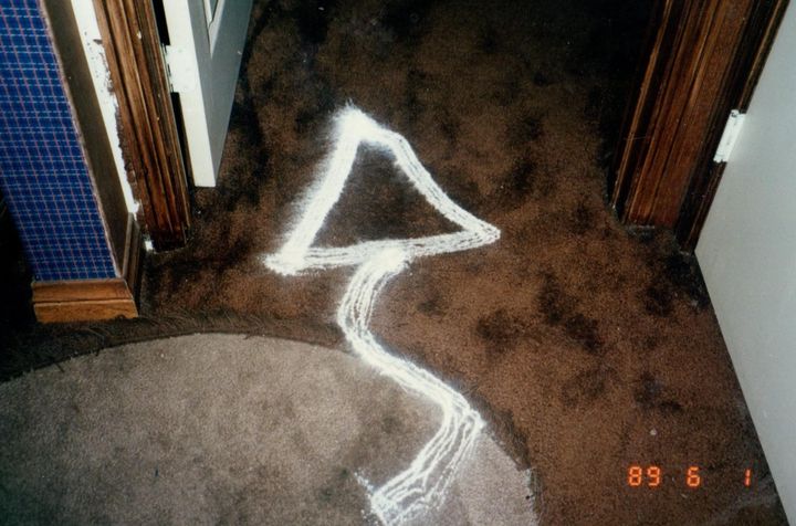 "Found on the living room carpet, this instance of the triangular symbol appeared to have been created from baby powder," the author writes of this photograph, dated June 1, 1989.