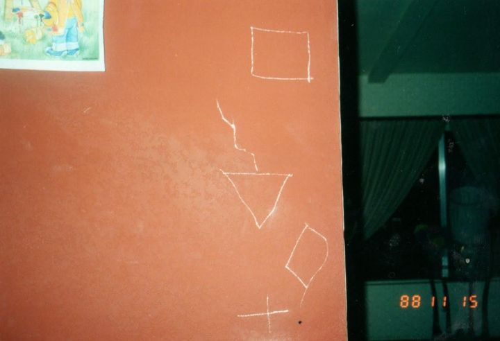 "These symbols were gouged into the wall of the staircase," the author writes of this photo from Nov. 15, 1988.