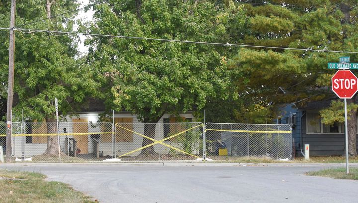 Police tape blocks off the Excelsior Springs residence of Timothy M. Haslett Jr., after the home was boarded up and fenced off Monday following a days-long execution of a search warrant.