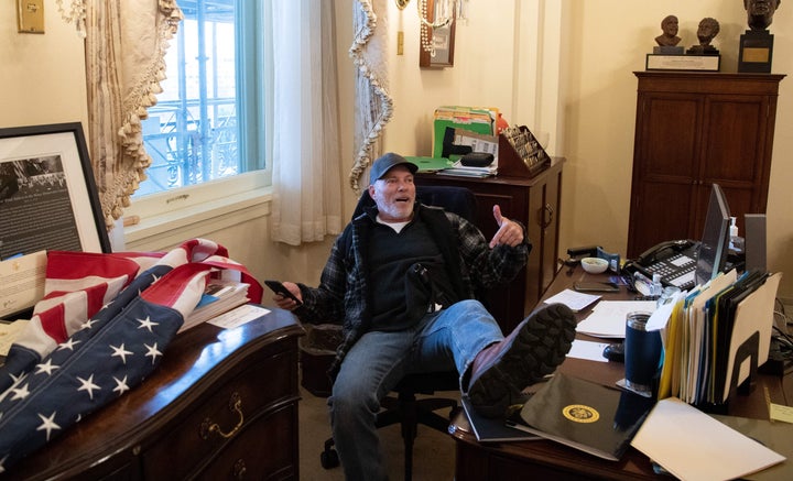 Richard Barnett, a supporter of former President Donald Trump, sat inside the office of House Speaker Nancy Pelosi during the Jan. 6, 2021 insurrection at the U.S. Capitol.