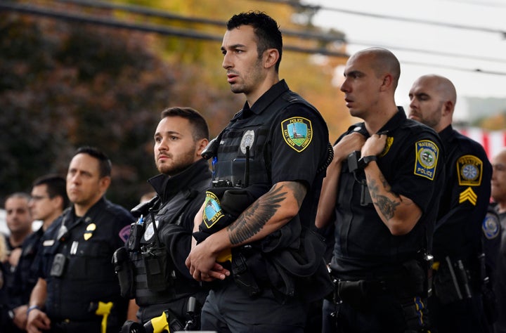 Police officers from towns across Connecticut stand at the scene where two police officers were killed in Bristol, Connecticut on Thursday.