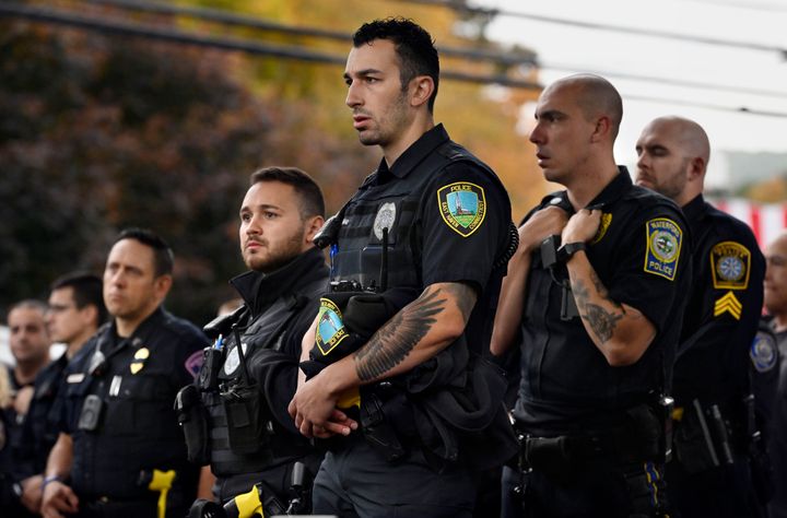 Police officers from towns across Connecticut stand at the scene where two police officers were killed in Bristol, Connecticut on Thursday.