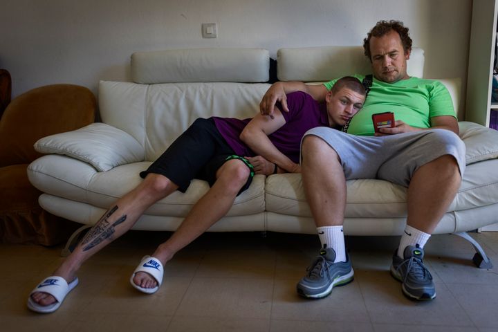 Timofey, left, and Denys Lopatkin watch TikTok videos from Ukraine in Loue, western France, on July 2, 2022.