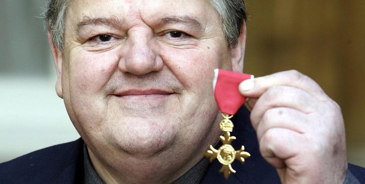 Robbie Coltrane with his OBE after receiving it from the Queen at Buckingham Palace.