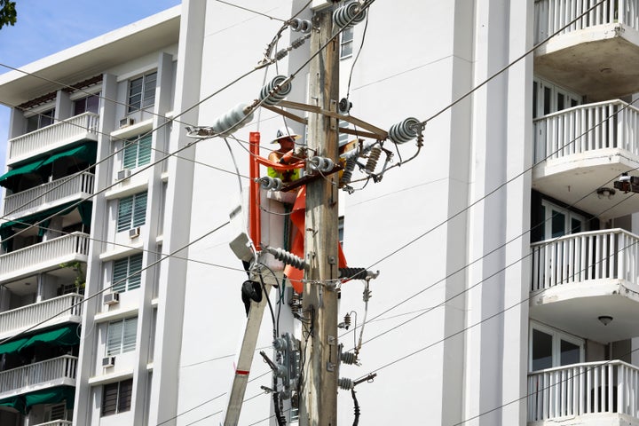 LUMA workers repair a power line in San Juan, Puerto Rico, on Sept. 20.