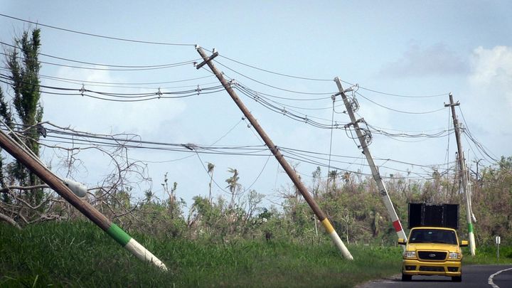 Power lines hang precariously on Oct. 14, 2017, on the side of a road near San Isidro, Puerto Rico, about two weeks after Hurricane María devastated the island.