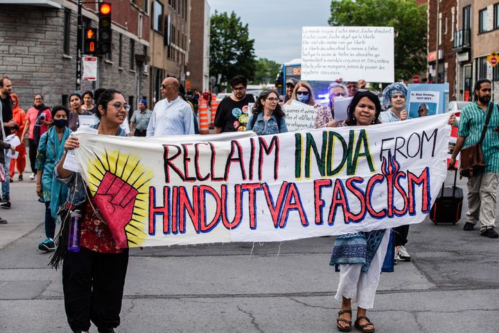 Demonstrators march on the street while holding a banner during a protest in Montreal, Canada, on June 30, 2022. Demonstrators gathered to protest against the so-called Hindu ethno-nationalist rule of Indian Prime Minister Narendra Modi. The protest was organized by the South Asian Diaspora Action Collective (SADAC) and the South Asia Forum (CERAS).