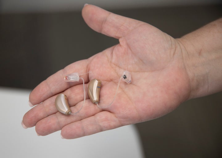 BOCA RATON, FLORIDA - OCTOBER 19: Jennifer Nealon, Marketing Director at Hear Again America, holds hearing aids that they sell on October 19, 2021 in Boca Raton, Florida. The Food and Drug Administration announced that people with mild or moderate hearing loss could soon buy hearing aids without a medical exam or special fitting. The agency says 37.5 million American adults have difficulties hearing. (Photo by Joe Raedle/Getty Images)