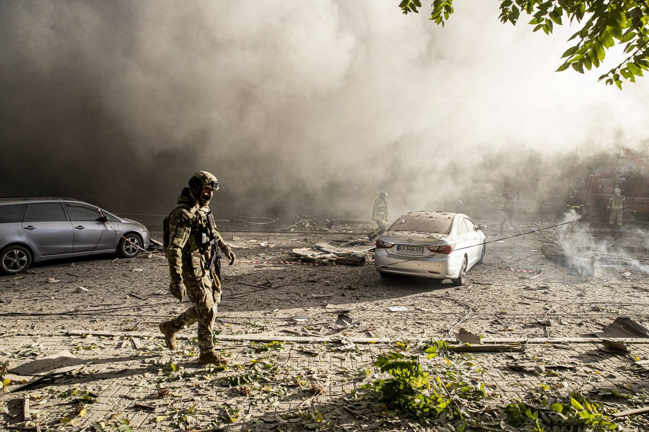Firefighters and Ukrainian soldiers conduct work after the Russian drone attacks in Kyiv, Ukraine on October 17, 2022.