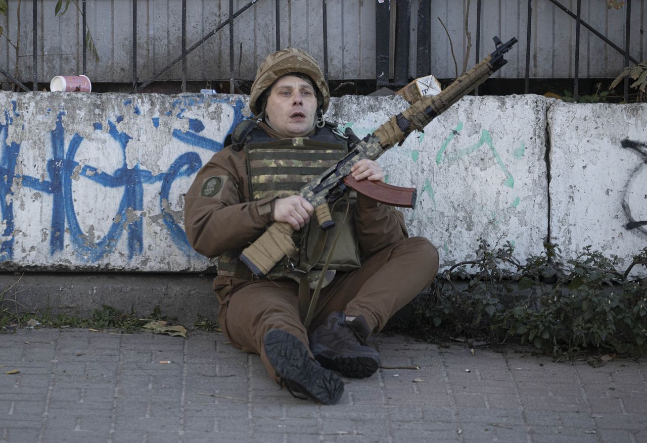 A soldier is seen sitting on the ground after Russian attacks in Kyiv, Ukraine on October 17, 2022.