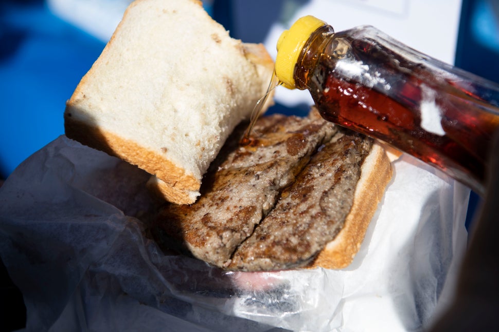 The famous scrapple sandwich. Here, a person puts syrup on their scrapple.