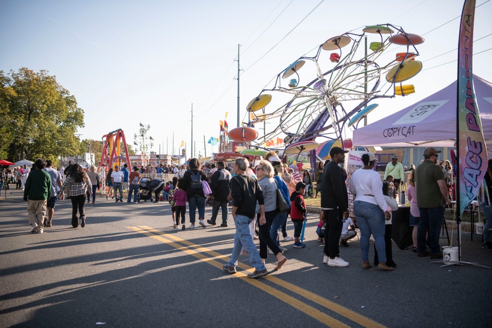 Crowds of people enjoy the carnival.