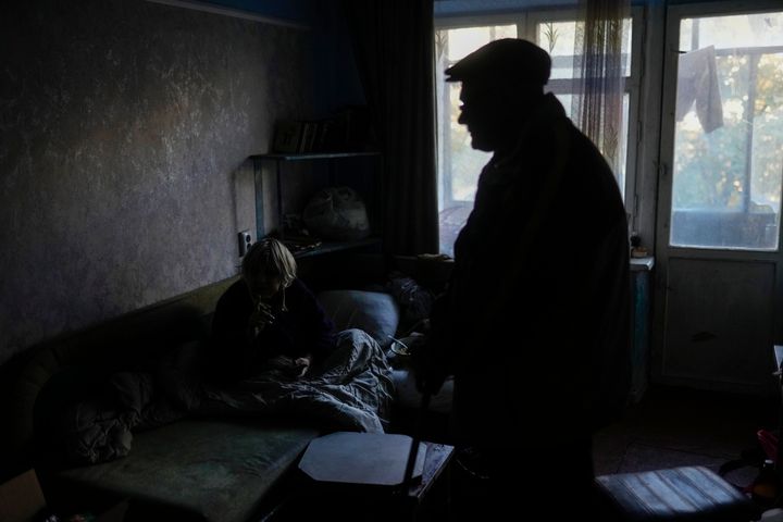 Zoya Sevrukova, left, and her son Anton talk at the living room of their apartment in Kivsharivka, Ukraine, on Oct. 16, 2022.