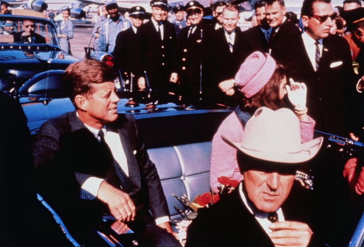 President John F. Kennedy sits in a motorcade shortly before he was fatally shot in 1963. His death sparked decades of conspiracy theories and distrust in the government.