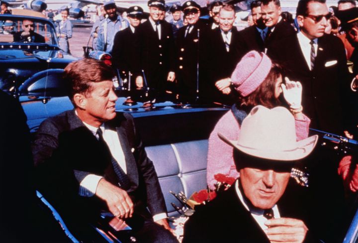 President John F. Kennedy sits in a motorcade shortly before he was fatally shot in 1963. His death sparked decades of conspiracy theories and distrust in the government.