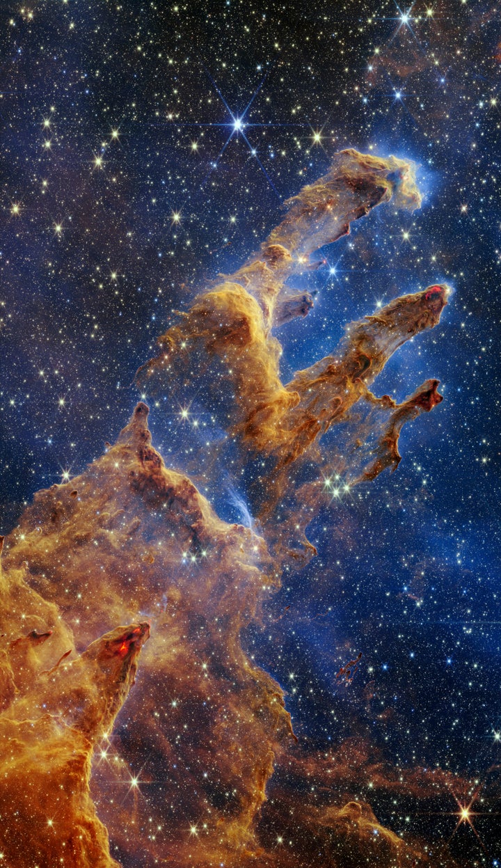 This image released by NASA on Wednesday, Oct. 19, 2022, shows the Pillars of Creation, captured by the James Webb Space Telescope in near-infrared-light view. (NASA, ESA, CSA, STScI via AP)