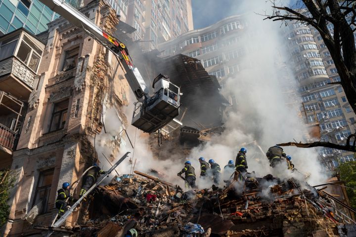 Firefighters work after a drone attack on buildings in Kyiv, Ukraine, on Oct. 17, 2022. 