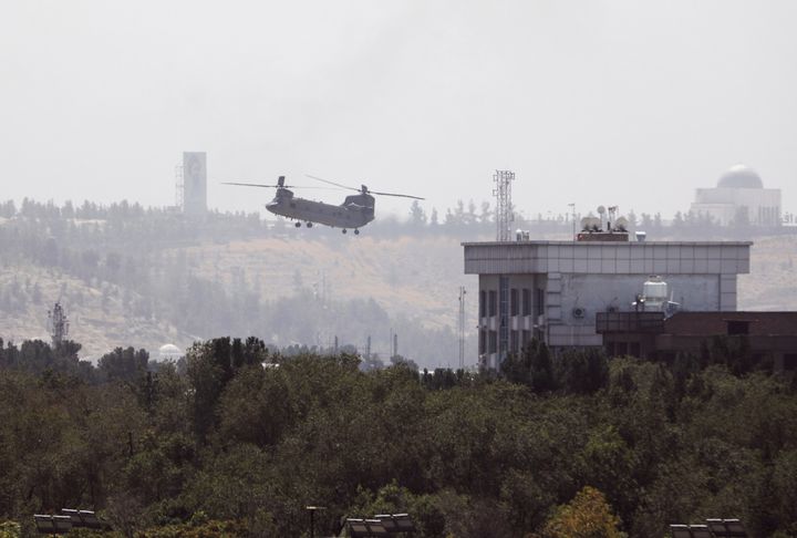 A U.S. Chinook helicopter flies near the U.S. Embassy in Kabul, Afghanistan. An Afghanistan couple says U.S. Marine Corps attorney Joshua Mast took their baby and is raising her as his own in the U.S.