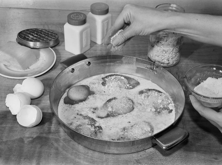 A home cook makes baked eggs as a meat substitute in 1942. 