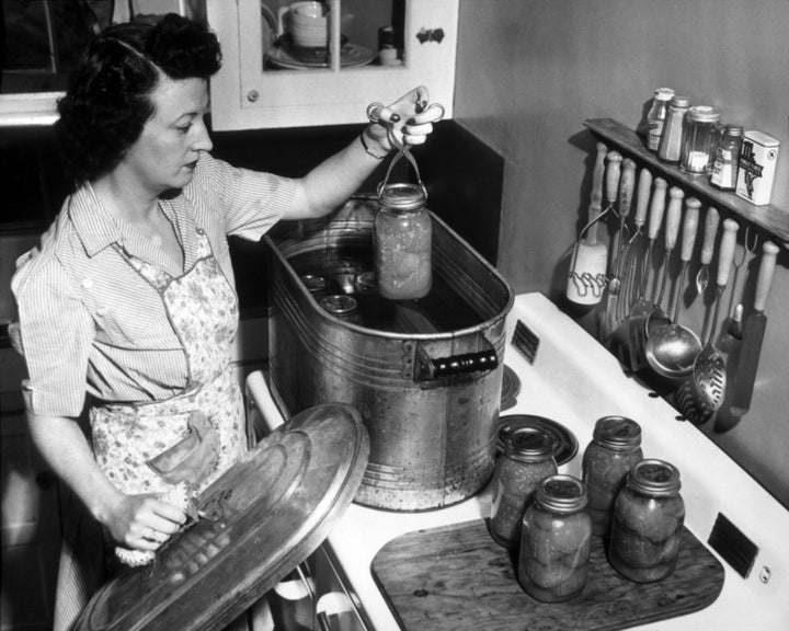 A home cook preserves tomatoes grown in her victory garden in 1944.