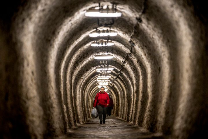 A woman walks inside an access gallery of the Salina Turda, a former salt mine turned touristic attraction, now listed by emergency authorities as a potential civil defense shelter in Turda, central Romania, on Oct. 17, 2022.