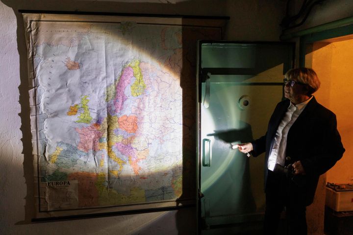 Ewa Karpinska, spokesperson for the steel production plant ArcelorMittal Warsaw, shows an old map in a Cold War shelter under the plant in Warsaw, Poland, on Oct. 20, 2022.