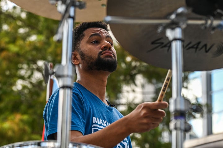 Maxwell Frost, a Democratic candidate for Florida's 10th Congressional district, plays the drums during the Pride Parade in Orlando, Florida, on October 15, 2022.