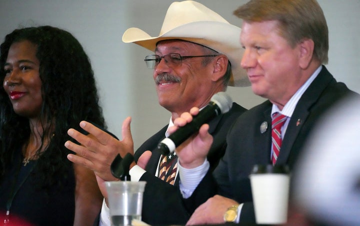 From left, Kristina Karamo, candidate for Michigan secretary of state, Mark Finchem, candidate for Arizona secretary of state, and Jim Marchant, candidate for Nevada secretary of state, attend a conference on conspiracy theories about voting machines and discredited claims about the 2020 presidential election at a hotel in West Palm Beach, Florida, Sept. 10, 2022.