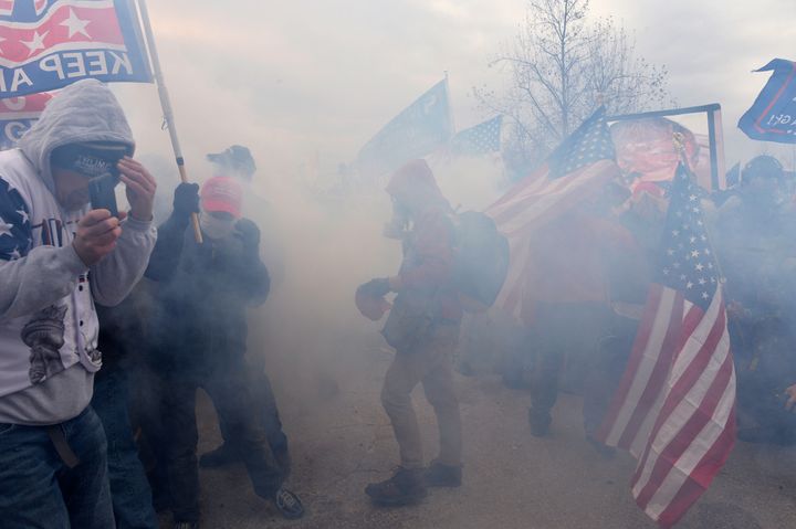 Trump supporters clash with police and security forces as they storm the U.S. Capitol surrounded by tear gas in Washington, DC on January 6, 2021. (Photo by JOSEPH PREZIOSO/AFP via Getty Images)