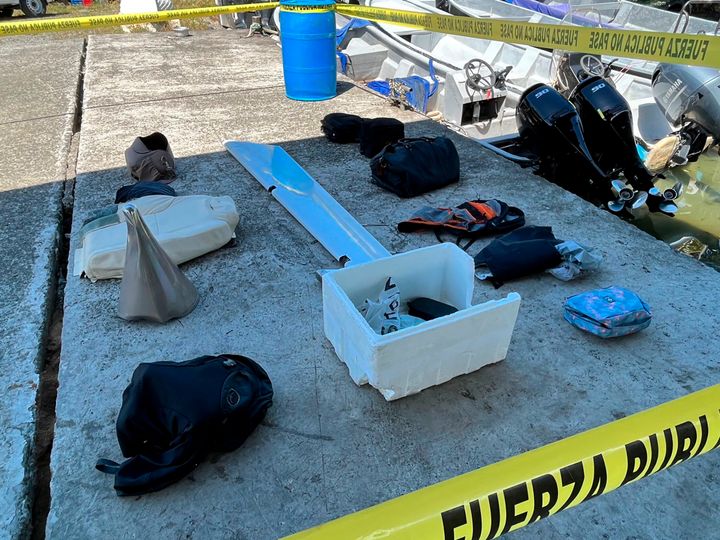 This handout photo provided by Costa Rica's Public Security Ministry shows flight passengers' personal belongings recovered from Caribbean waters along with pieces of a twin-engine turboprop aircraft on Saturday.