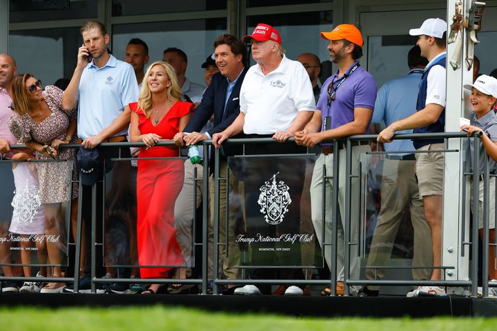Tucker Carlson — pictured center next to Donald Trump, got support from Marjorie Taylor Greene and Donald Trump Jr. (right) — in his beef with Rep. Tom Emmer.