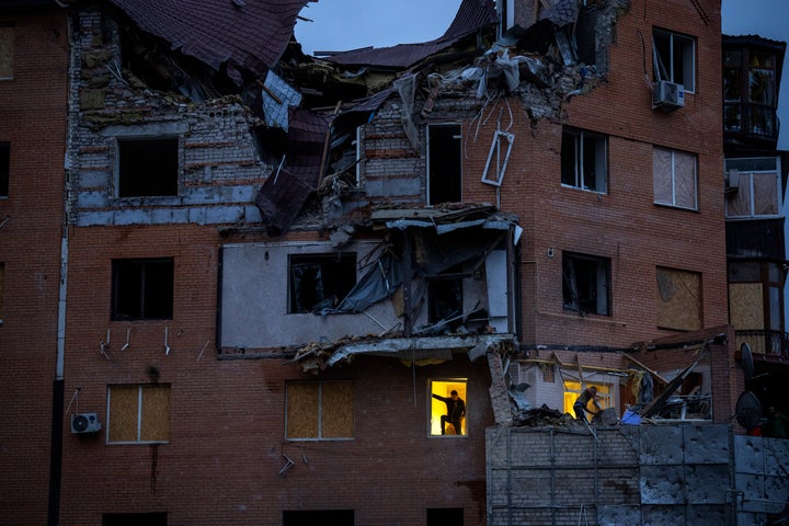 People check the damage at their apartments hit by a Russian missile in Mykolaiv, on Oct. 23, 2022.