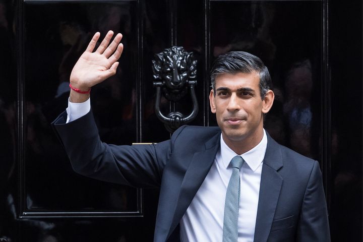 Rishi Sunak waves to the media as he enters No.10 Downing Street for the first time as PM