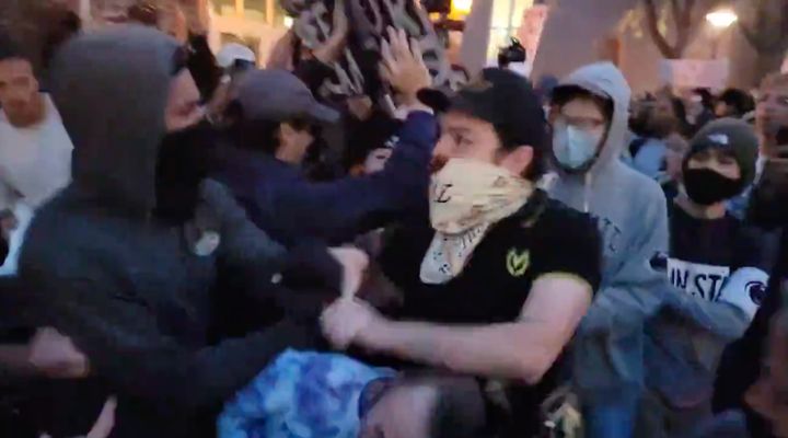 A member of the Proud Boys fights with student protesters on Penn State University's campus, prior to an event that would feature Proud Boys founder Gavin McInnes on campus.