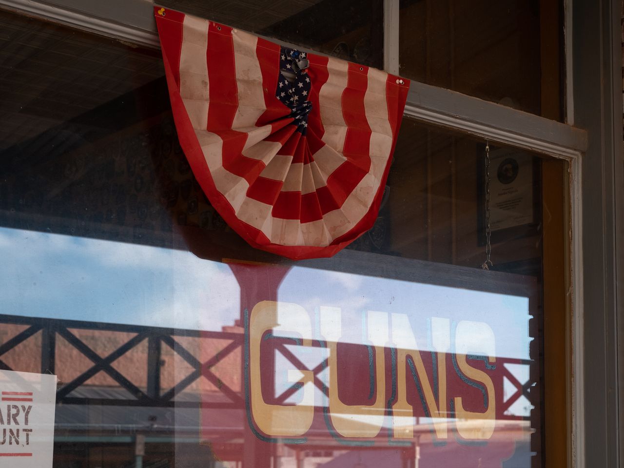A shop window in Tombstone, Arizona, advertises guns sold inside on Aug. 6, 2022.