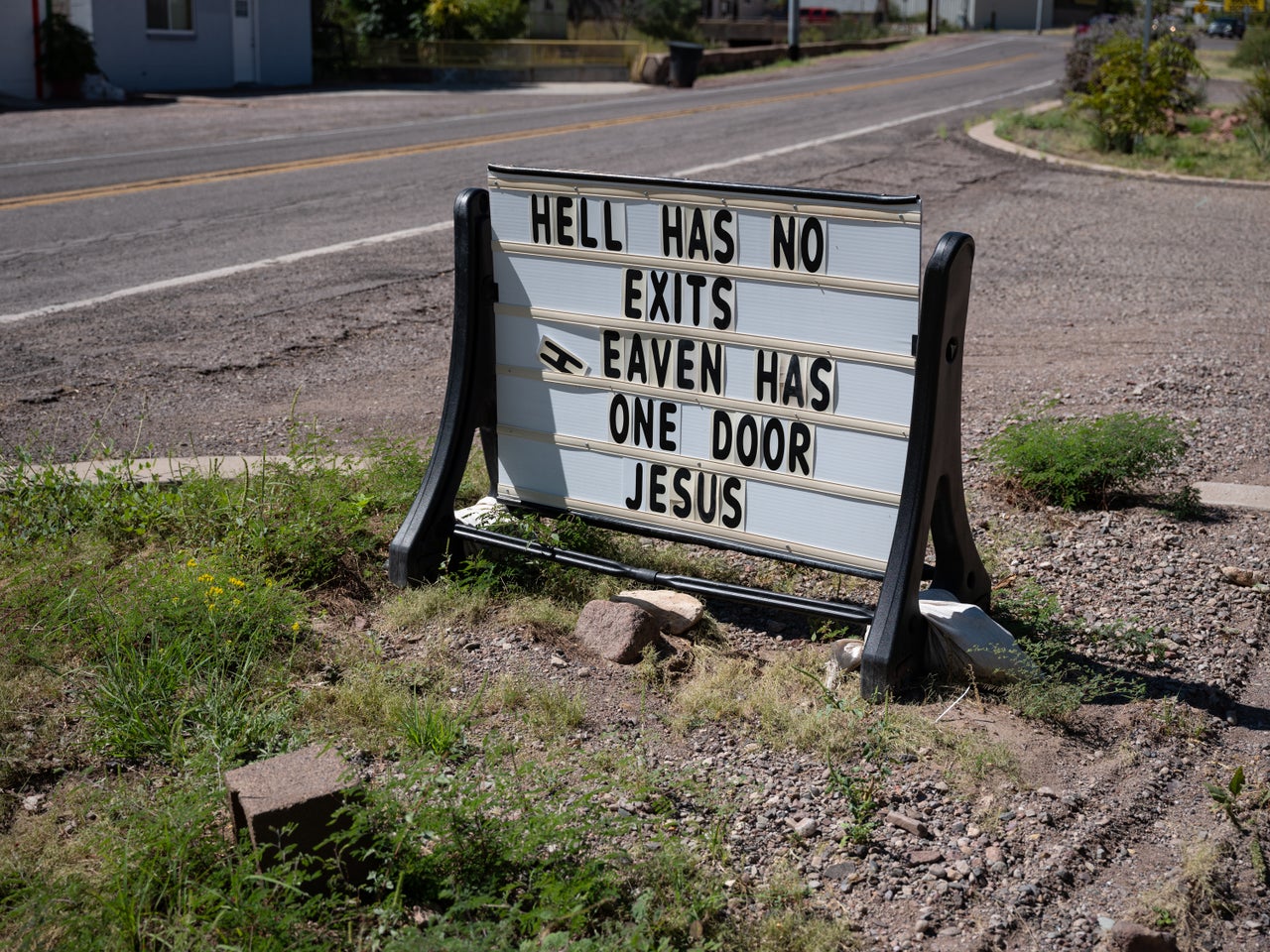 Along a road in Clifton, Arizona, a sign depicts a Christian message for passers-by.