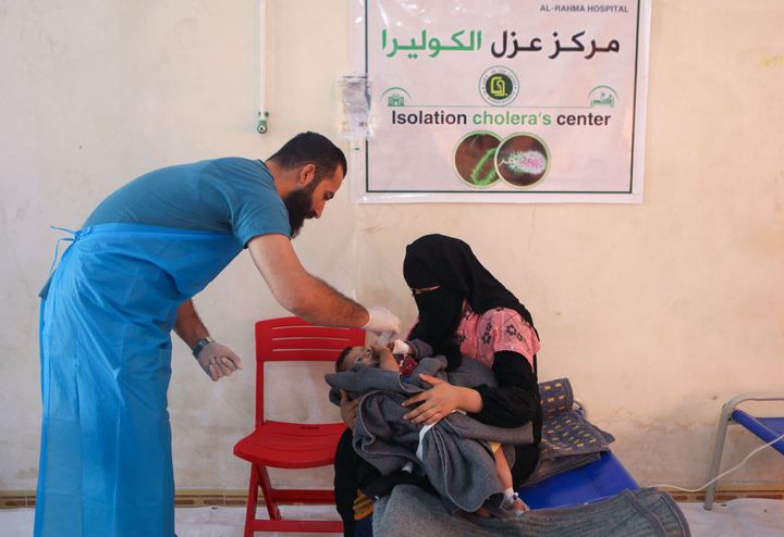 A medic treats a baby brought by his mother at a recently opened medical center for cholera cases in the Syrian town of Darkush, on the outskirts of the rebel-held northwestern province of Idlib, on Oct. 22, 2022. The disease is making its first major comeback since 2009 in Syria, where nearly two-thirds of water treatment plants, half of pumping stations and one-third of water towers have been damaged by more than a decade of war, according to the United Nations. 