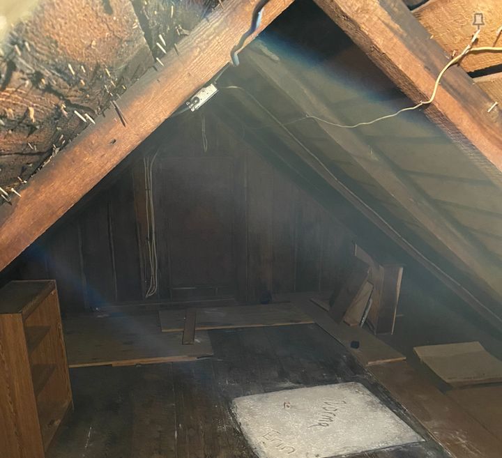 The house's attic space where the author believes he may have been communicating with the spirit of a young boy.
