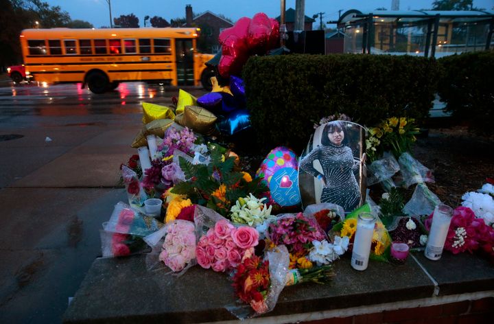 A photo of Alexandria Bell rests at the scene of a growing floral memorial to the victims of a school shooting at Central Visual & Performing Arts High School, Tuesday, Oct. 25, 2022, in St. Louis. Bell and teacher Jean Kuczka were killed, along with the gunman, in the shooting. 