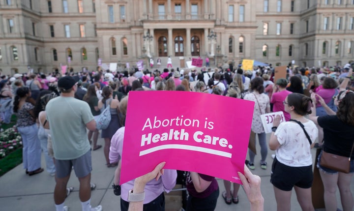 Abortion-rights protesters attend a rally following the United States Supreme Court's decision to overturn Roe v. Wade outside the state capitol in Lansing, Mich., Friday, June 24, 2022.