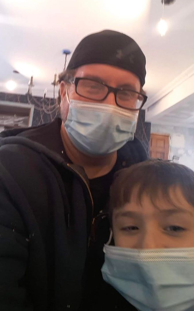 The author's brother, Rob, and his son during the COVID-19 pandemic. "This is the only kind of mask my brother wears around his kid!" the author writes. "No rubber satanic ones for Rob because he’s breaking the cycle of terror."