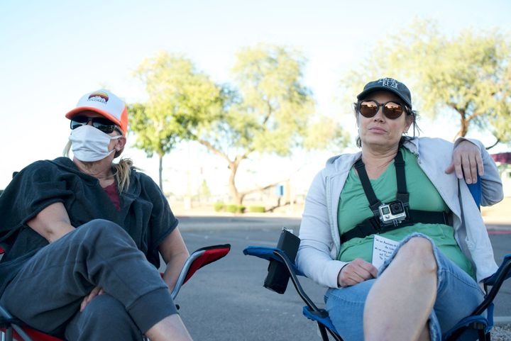 Lynnette (left) and Nicole watch a ballot drop box Monday as part of an effort to investigate nonexistent election fraud, based on allegations from the movie "2000 Mules," while sitting in a parking lot in Mesa, Arizona.