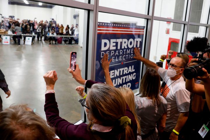 Supporters of President Donald Trump bang on the glass and chant slogans outside the room where absentee ballots for the 2020 general election were being counted on Nov. 4, 2020, in Detroit.