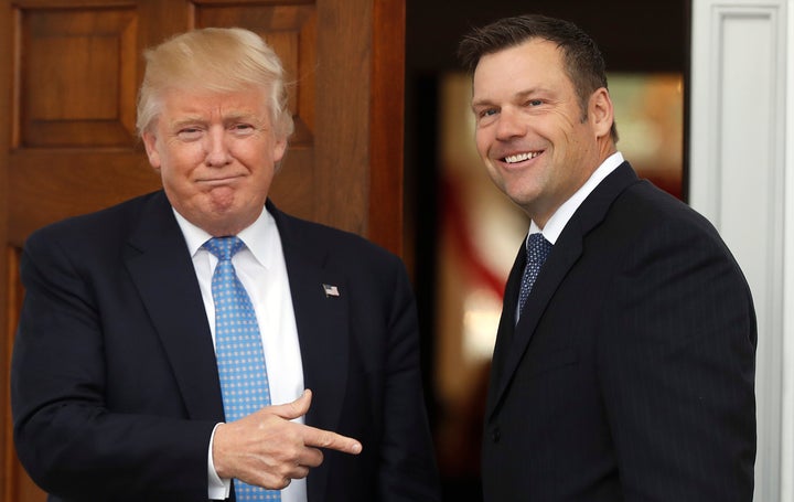 Former President Donald Trump greets then-Kansas Secretary of State Kris Kobach, as he arrives at the Trump National Golf Club Bedminster clubhouse in Bedminster, N.J.