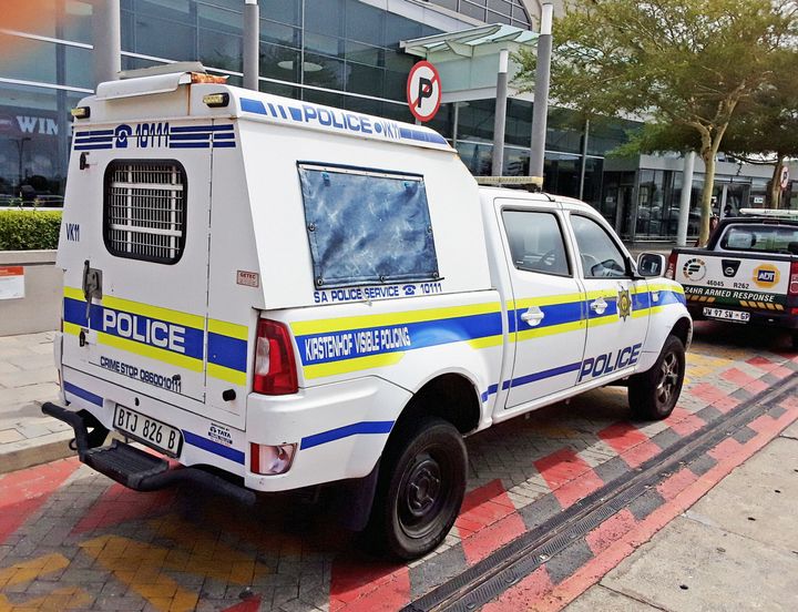 Cape Town, South Africa - January 28, 2022: A van emblazoned with the logo and colors of the South African Police Service parked in the emergency zone outside a shopping mall in the southern suburbs of Cape Town.