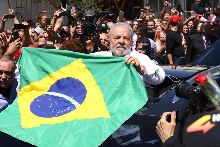 Candidate Luiz Inácio Lula Da Silva of Workers’ Party greets supporters as he leaves Escola Estadual Firmino Correia De Araújo after casting his vote and giving a news conference Sunday in Sao Bernardo do Campo, Brazil. Brazilians vote for president again after neither Lula nor incumbent Jair Bolsonaro reached enough support to win in the first round.