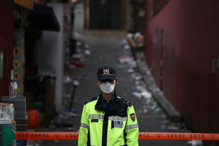  A police officer stands guard in front of the scene of the deadly stampede